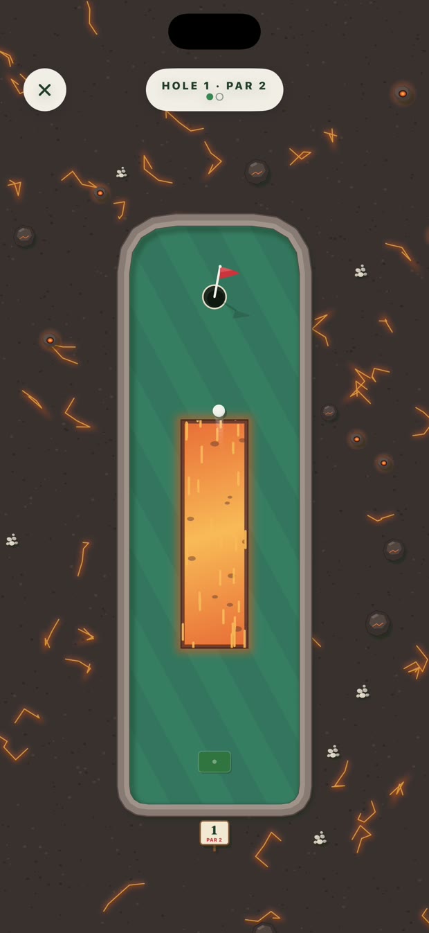 Greens Inferno course: the ball crossing a glowing lava flow on a green hole set in dark rock