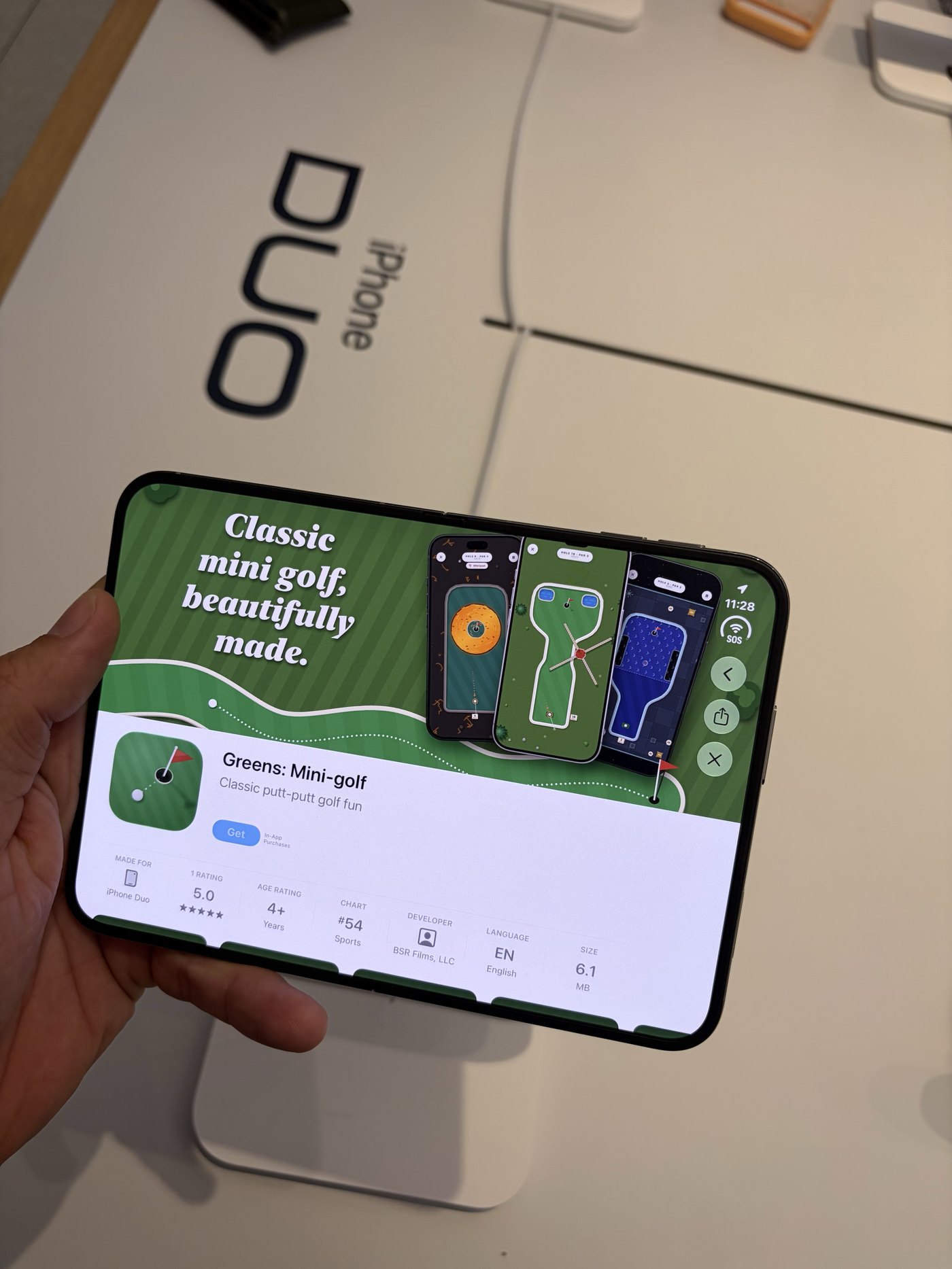 The iPhone Duo demo unit showing the Greens App Store page: Classic mini golf, beautifully made