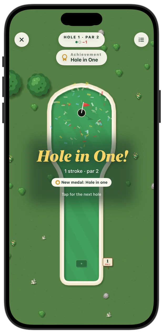 A ball dropping into the cup for a hole in one, with confetti